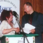Drummer of the Year Maureen Brown (L) is congratulated by emcee John Northcott.